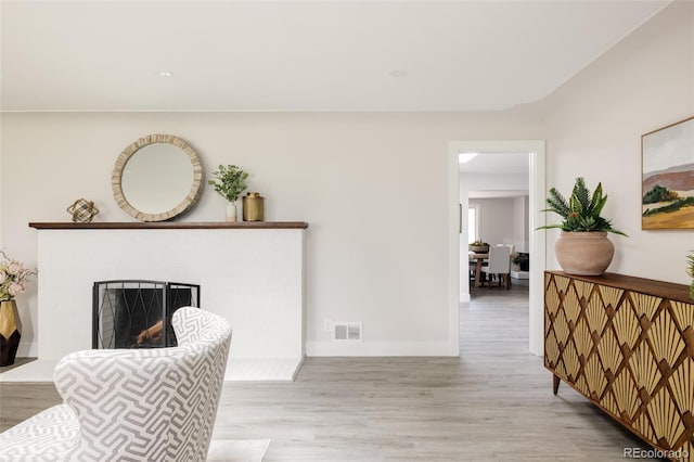 3540 Everett St, Wheat Ridge, CO 80033 - living room featuring wood finished floors, a fireplace, and baseboards