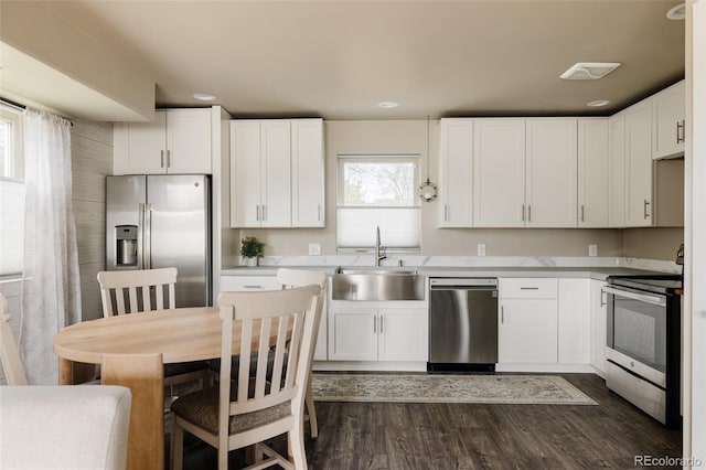 3540 Everett St, Wheat Ridge, CO 80033 - kitchen featuring stainless steel appliances, a sink, white cabinetry, and recessed lighting
