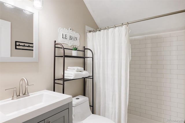 3540 Everett St, Wheat Ridge, CO 80033 - full bath featuring toilet, a stall shower, vaulted ceiling, and vanity