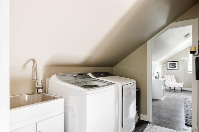 3540 Everett St, Wheat Ridge, CO 80033 - clothes washing area with washer and clothes dryer, dark wood-style flooring, and baseboards