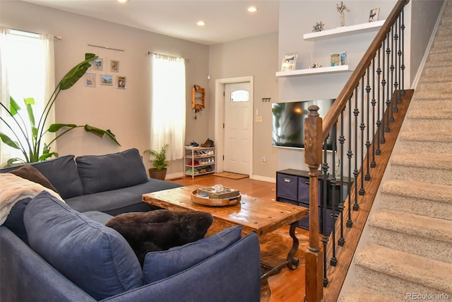 living room with baseboards, stairway, wood finished floors, and recessed lighting