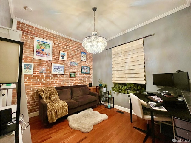 home office featuring visible vents, brick wall, wood finished floors, crown molding, and a notable chandelier