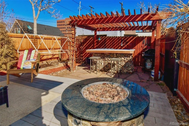 view of patio / terrace featuring a fenced backyard, outdoor dry bar, and a pergola