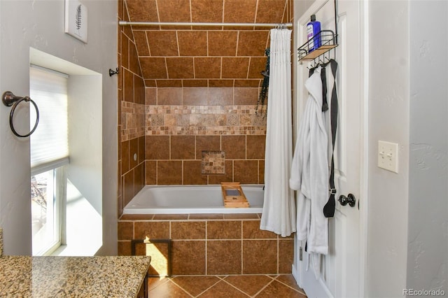 bathroom featuring tiled shower / bath combo and tile patterned floors