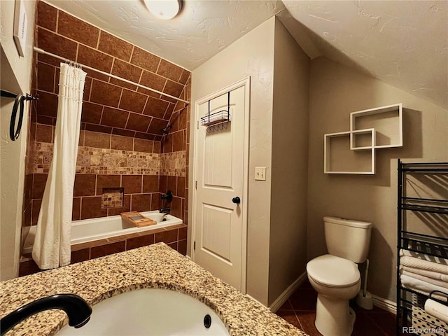 full bathroom featuring toilet, baseboards, vaulted ceiling, tiled shower / bath, and tile patterned floors