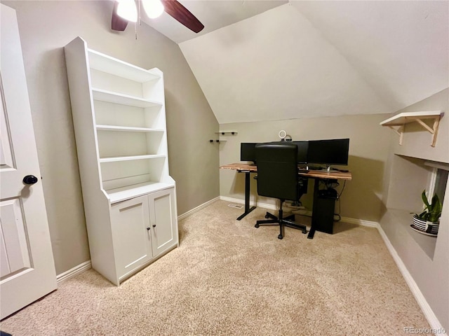 home office with a ceiling fan, lofted ceiling, light colored carpet, and baseboards