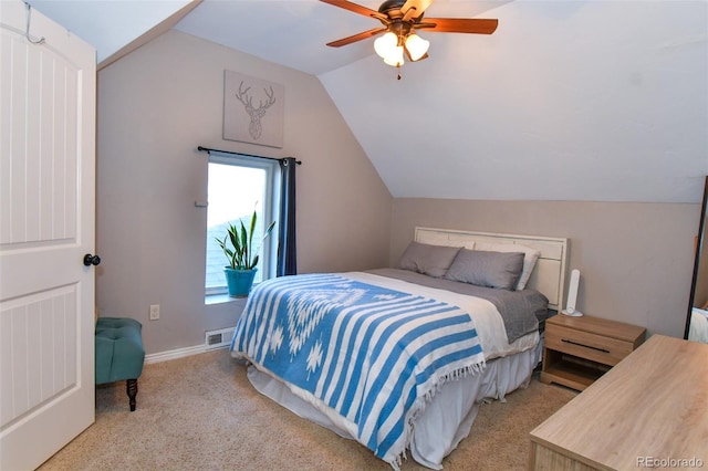 carpeted bedroom with a ceiling fan, visible vents, vaulted ceiling, and baseboards