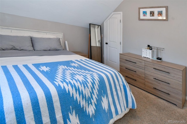 bedroom featuring lofted ceiling and carpet floors