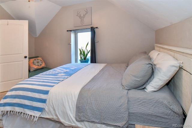 bedroom featuring access to outside and vaulted ceiling