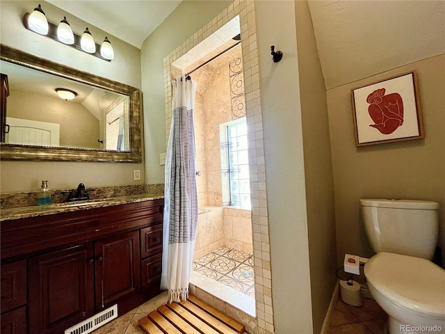 full bath with toilet, vanity, tiled shower, and tile patterned floors