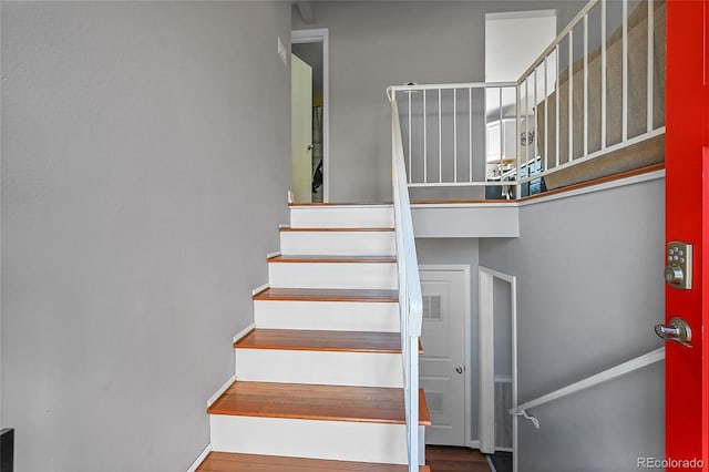 stairs with visible vents and wood finished floors