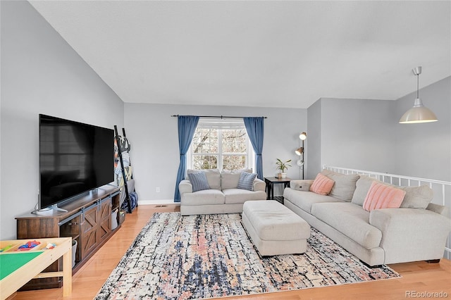 living area with light wood-type flooring and baseboards