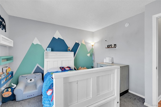 bedroom with a textured ceiling, carpet flooring, and baseboards