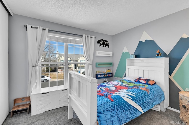 carpeted bedroom featuring a textured ceiling and a wall mounted air conditioner