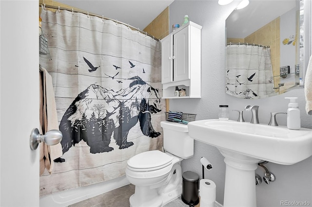 bathroom with a shower with shower curtain, a textured wall, toilet, and tile patterned floors