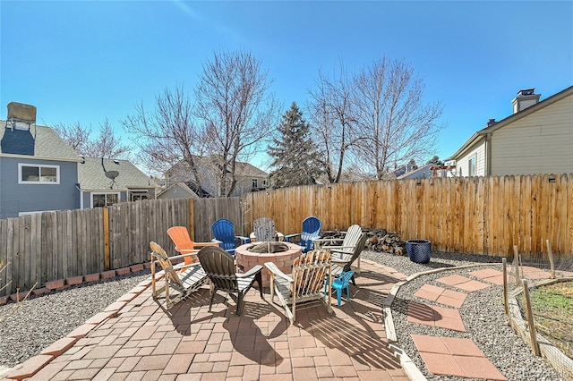 view of patio / terrace featuring an outdoor fire pit and a fenced backyard