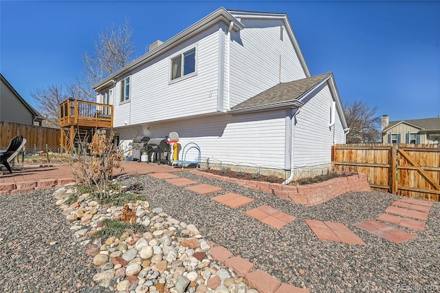 back of house featuring a patio and fence