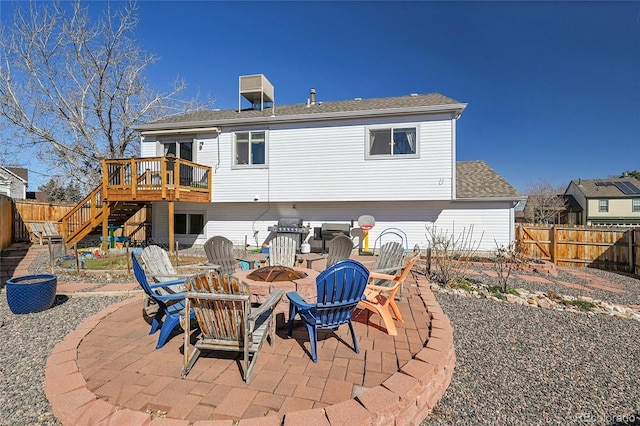 rear view of property with an outdoor fire pit, a patio area, a fenced backyard, and stairs