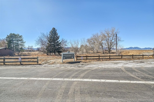 view of street with a rural view and a mountain view