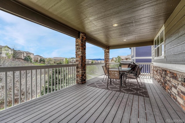deck with a residential view and outdoor dining space