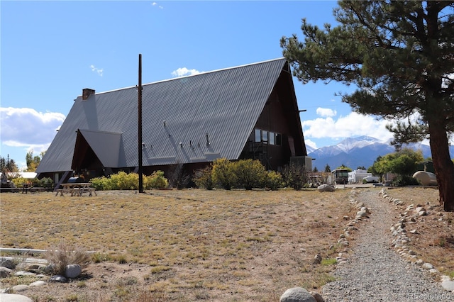 view of side of home with a mountain view