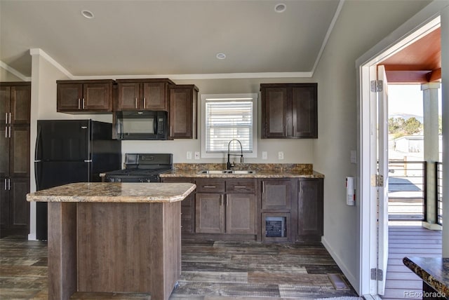 kitchen featuring a center island, sink, black appliances, and ornamental molding