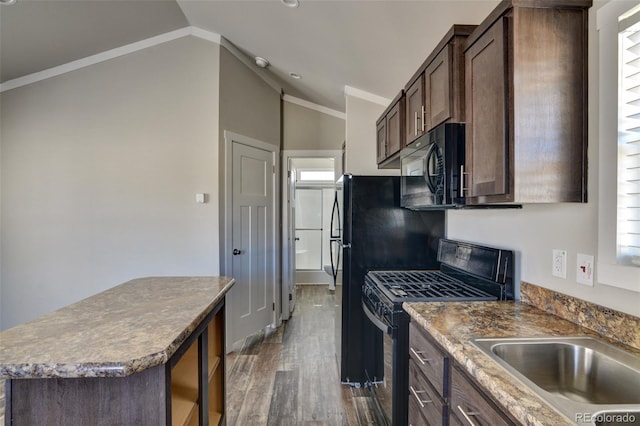 kitchen with lofted ceiling, gas stove, a kitchen island, crown molding, and dark hardwood / wood-style flooring