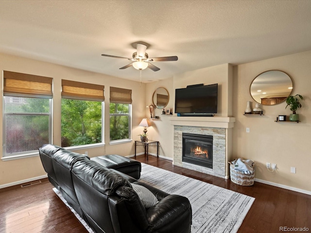 11945 S Saunter Ln, Parker, CO 80138 - living area featuring ceiling fan, a fireplace, hardwood / wood-style floors, and a textured ceiling