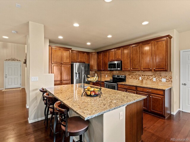 11945 S Saunter Ln, Parker, CO 80138 - kitchen featuring stainless steel appliances, light stone countertops, dark wood-type flooring, decorative backsplash, and recessed lighting