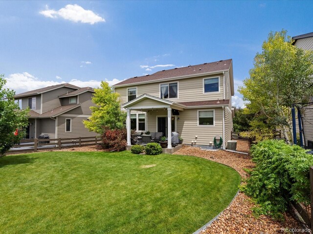 11945 S Saunter Ln, Parker, CO 80138 - back of property with outdoor lounge area, a fenced backyard, and a patio area