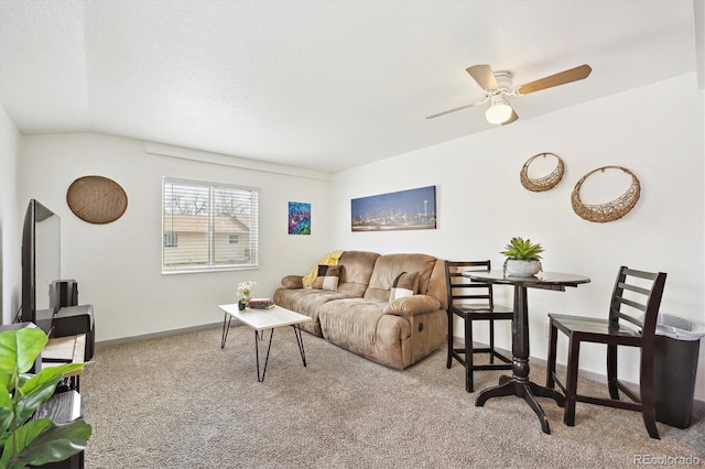 carpeted living room featuring baseboards, a textured ceiling, and a ceiling fan