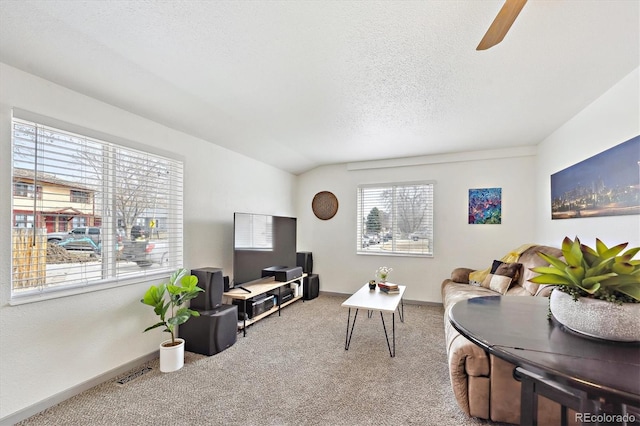 carpeted living area featuring visible vents, a ceiling fan, baseboards, and a textured ceiling