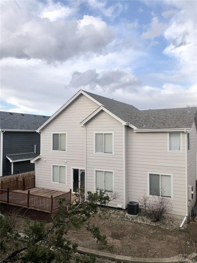 8769 S Dudley St, Littleton, CO 80128 - back of property with a wooden deck and central AC unit