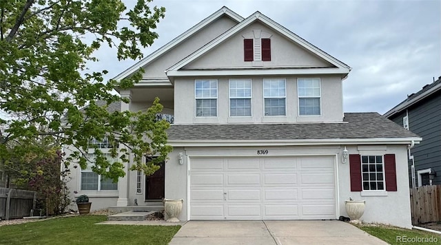 8769 S Dudley St, Littleton, CO 80128 - traditional-style house featuring fence, an attached garage, stucco siding, and concrete driveway