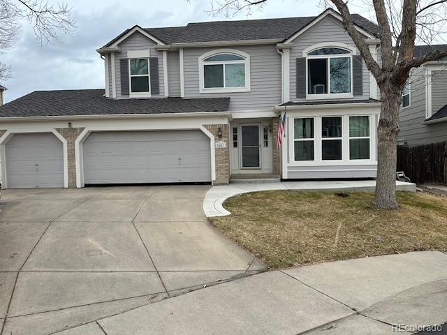 traditional home with concrete driveway and brick siding