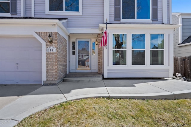 view of exterior entry with brick siding