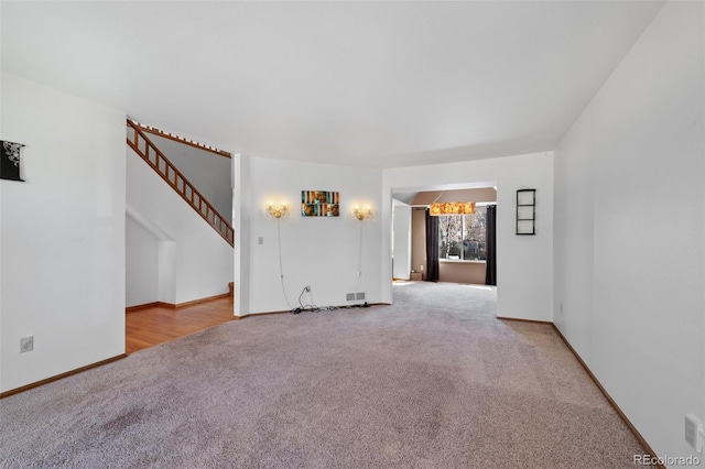 8441 Urban Ct, Arvada, CO 80005 - unfurnished living room featuring carpet flooring, stairs, and baseboards