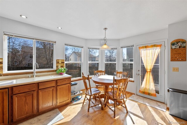 8441 Urban Ct, Arvada, CO 80005 - dining room with light wood finished floors and recessed lighting