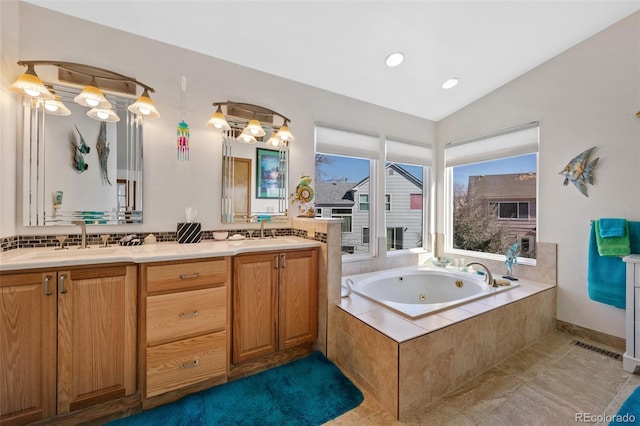 8441 Urban Ct, Arvada, CO 80005 - bathroom with a sink, a tub with jets, double vanity, and vaulted ceiling