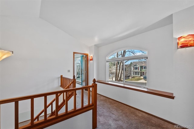 8441 Urban Ct, Arvada, CO 80005 - hall with baseboards, an upstairs landing, carpet floors, and vaulted ceiling