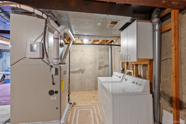 8441 Urban Ct, Arvada, CO 80005 - clothes washing area featuring cabinet space, visible vents, independent washer and dryer, and heating unit