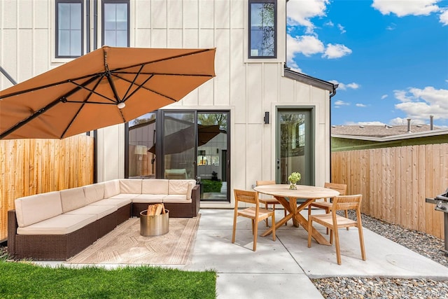 view of patio with a fenced backyard, outdoor dining area, and an outdoor hangout area
