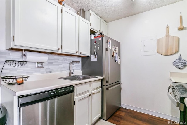 kitchen featuring sink, stainless steel appliances, backsplash, a textured ceiling, and white cabinets