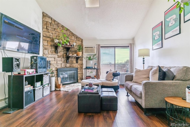 living room featuring a textured ceiling, a stone fireplace, dark wood-type flooring, and vaulted ceiling