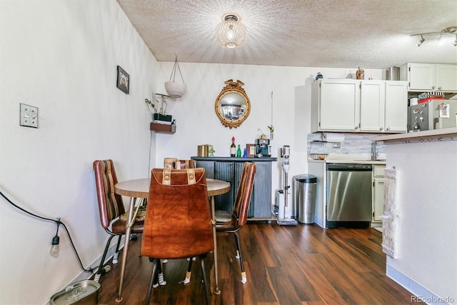 dining room with dark hardwood / wood-style flooring and a textured ceiling