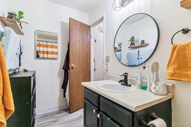 bathroom with vanity and hardwood / wood-style flooring