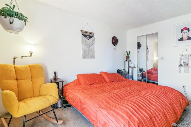 bedroom featuring carpet floors and a textured ceiling