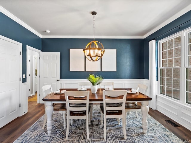 3043 W 109th Pl, Westminster, CO 80031 - dining room with a chandelier, wood finished floors, a decorative wall, ornamental molding, and wainscoting