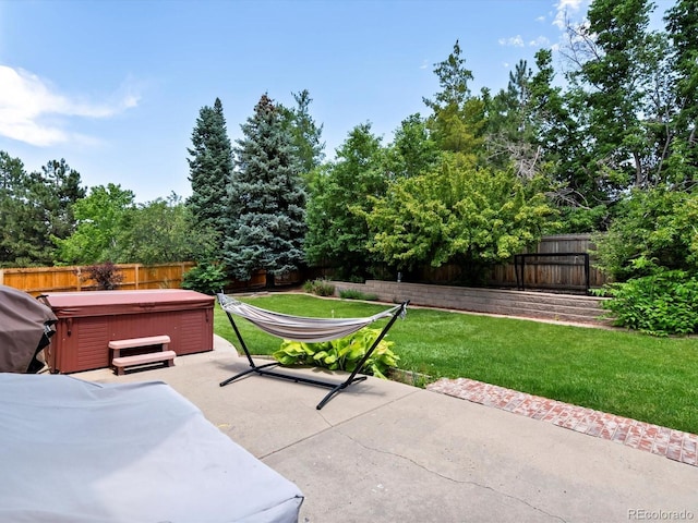 3043 W 109th Pl, Westminster, CO 80031 - fenced backyard featuring a hot tub, a patio, grilling area, and view of scattered trees