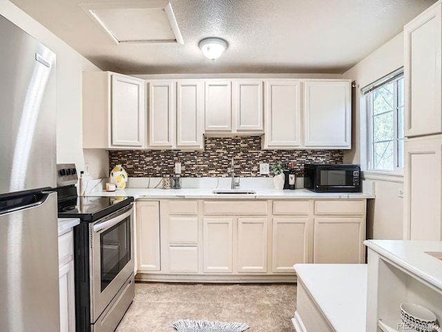 3304 W 3rd Ave, Denver, CO 80219 - kitchen featuring appliances with stainless steel finishes, decorative backsplash, light countertops, and white cabinets